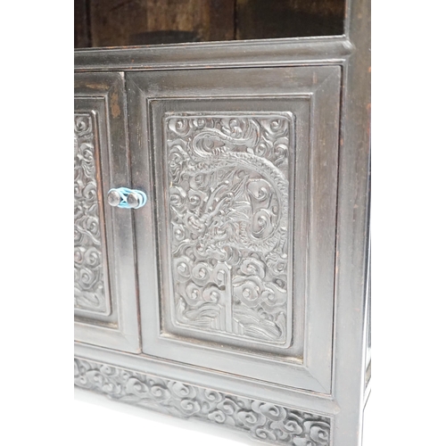 1321 - An early 20th century Chinese hongmu cabinet with carved cupboard doors, 61cm high