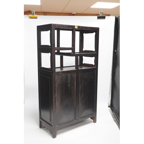 1321 - An early 20th century Chinese hongmu cabinet with carved cupboard doors, 61cm high