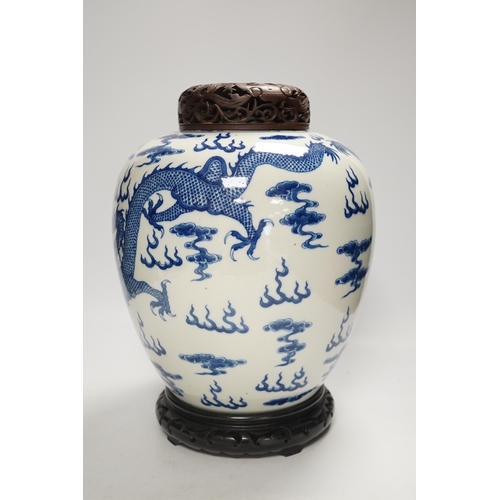 1324 - A large Chinese blue and white jar decorated with dragons chasing the flaming pearl together with un... 