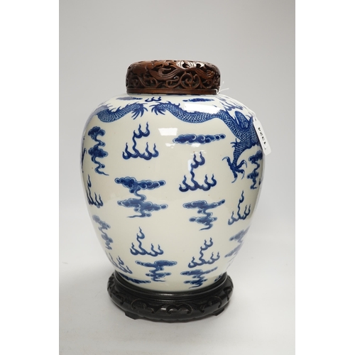 1324 - A large Chinese blue and white jar decorated with dragons chasing the flaming pearl together with un... 