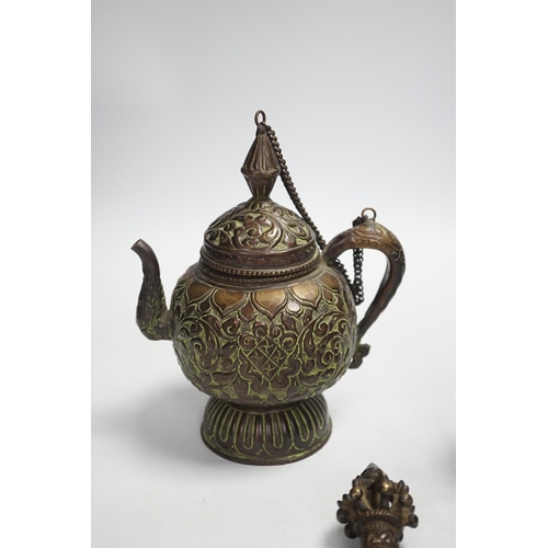 1339 - A Tibetan repousse teapot, a ghanta bell and a kartika chopper, tallest 19cm