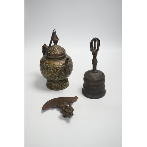 1339 - A Tibetan repousse teapot, a ghanta bell and a kartika chopper, tallest 19cm