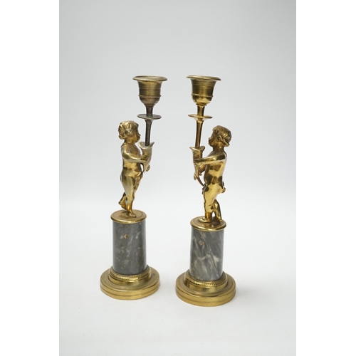 1381 - A pair of brass figural and candlesticks, 27cm high