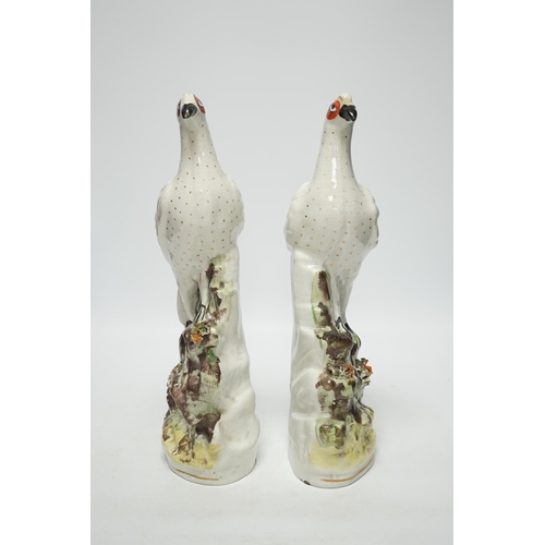 1414 - A pair of 19th century Staffordshire models of birds, each 32cm high