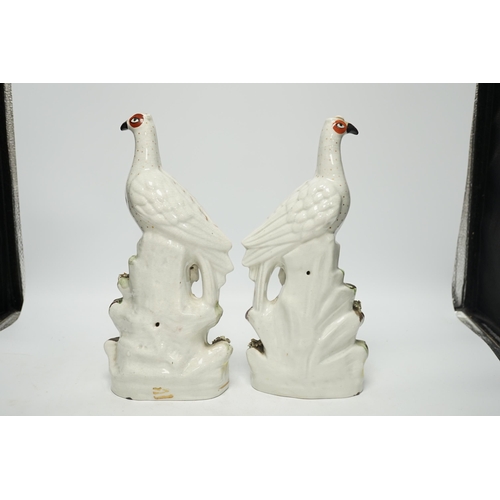 1414 - A pair of 19th century Staffordshire models of birds, each 32cm high