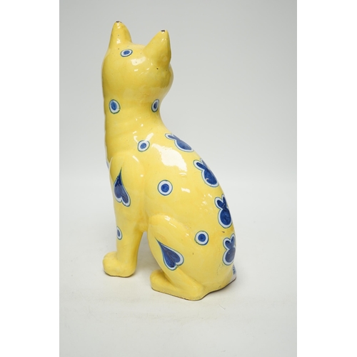 1417 - A Gallé yellow glazed model cat with glass eyes, signed E. Gallé, Nancy, 32cm high