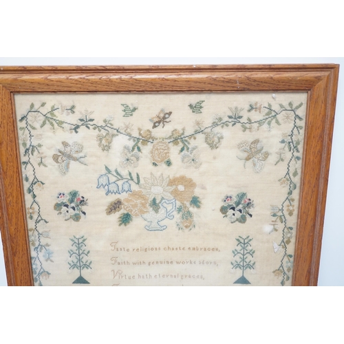 1420 - A framed sampler by Charlotte Betts, dated 1831, embroidered with a central religious verse, scrolli... 