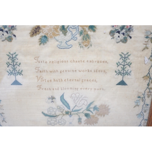 1420 - A framed sampler by Charlotte Betts, dated 1831, embroidered with a central religious verse, scrolli... 