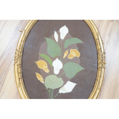 1448 - An oval framed cross stitch embroidery of a lily, indistinctly signed and dated, 80cm x 54cm