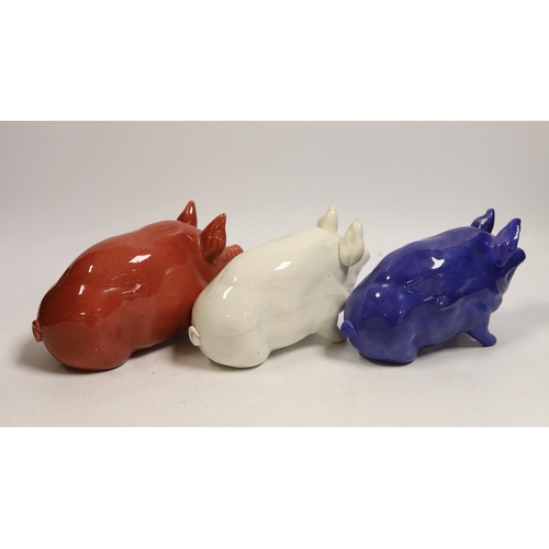 1476 - Three Wemyss ware pigs in cream, blue and pink glazes, 15cm