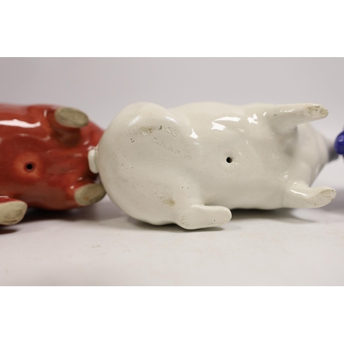 1476 - Three Wemyss ware pigs in cream, blue and pink glazes, 15cm