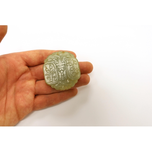 1515 - A Chinese carved jade pendant and another carving of a recumbent lion dog, largest 5cm