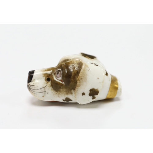 1530 - An early 19th century Staffordshire porcelain dogs head whistle, 4.5cm