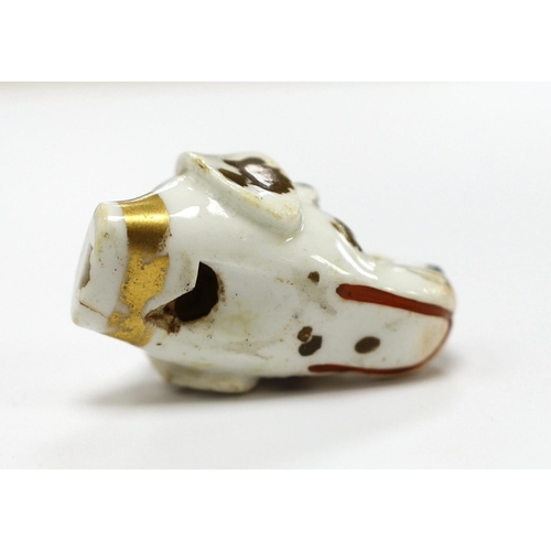 1530 - An early 19th century Staffordshire porcelain dogs head whistle, 4.5cm