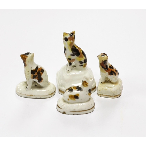 1537 - Four Staffordshire porcelain models of tortoiseshell cats, c.1830-50, three seated on shaped bases, ... 