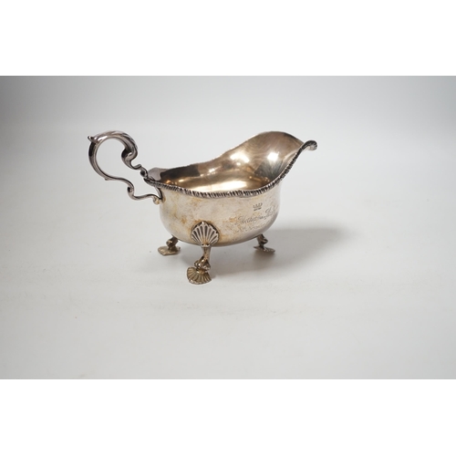 1854 - A George V silver sauceboat, on three shell feet, Thomas of New Bond Street, London, 1918, length 17... 