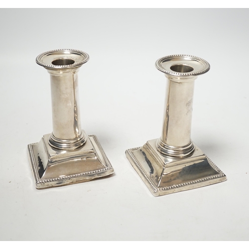 1870 - A pair of late Victorian silver dwarf candlesticks, with beaded borders, Edward Hutton, London, 1882... 