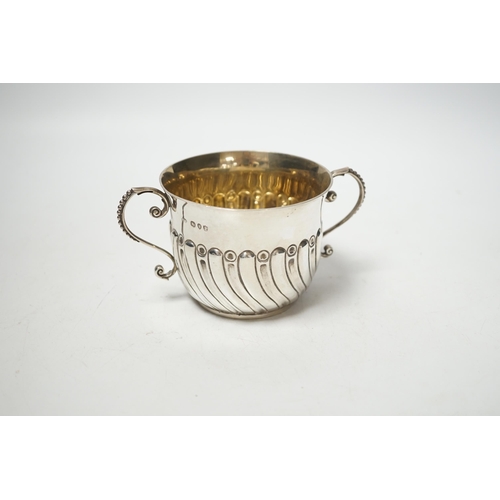 1874 - A late Victorian embossed silver porringer, Robert Stebbings, London, 1890, height 7cm, 4.9oz.... 