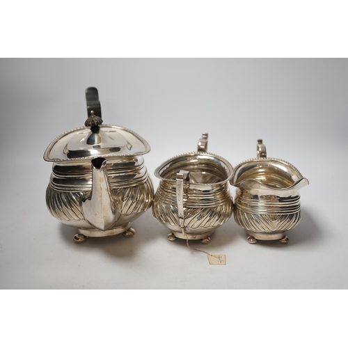 1885 - A George V demi fluted silver three piece tea set, Nathan & Hayes, Chester, 1913, gross weight 37.2o... 