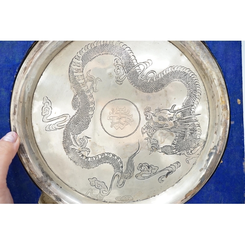 1888 - A Chinese white metal dragon salver, late 19th century, 20.2cm carded silk box base and two simila... 