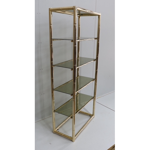 1007 - A Maison Jansen style faux bamboo brass and smoked glass five tier shelf unit, width 76cm, depth 39c... 