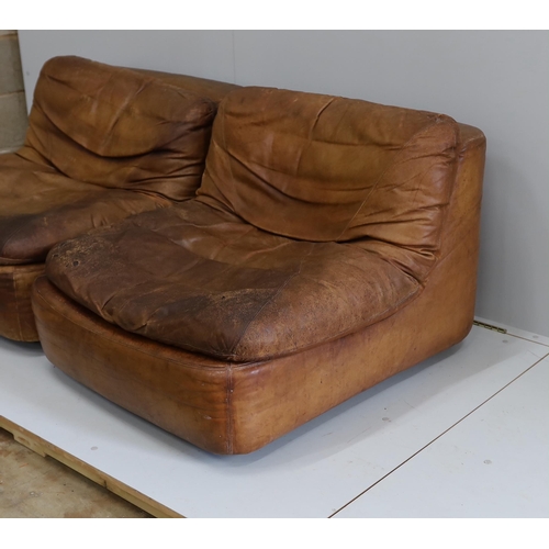 1034 - A pair of German Dreipunkt tan leather easy chairs, width 86cm, depth 96cm, height 60cm