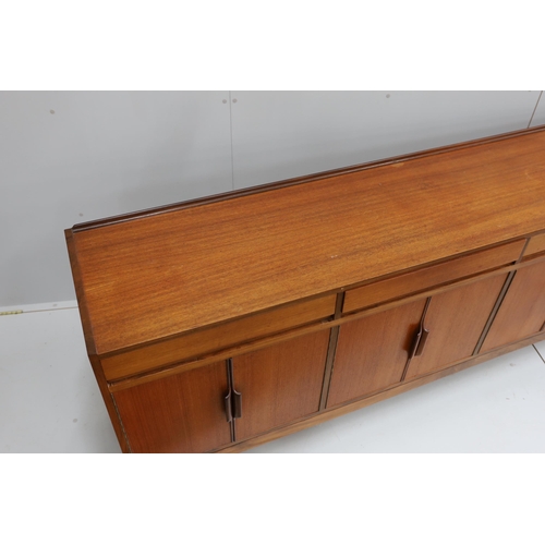 1042 - Robert Heritage for Archie Shine, a mid century teak sideboard, length 238cm, depth 46cm, height 86c... 