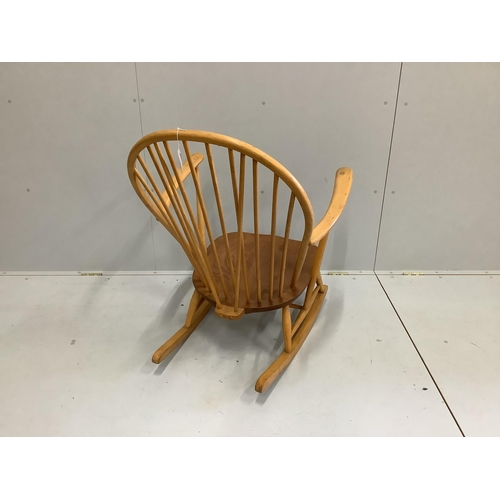 1066 - An Ercol elm and beech comb back rocking armchair, width 73cm, depth 78cm, height 95cm