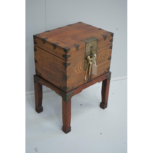 1103 - A Chinese brass mounted elm box on stand, width 42cm, depth 31cm, height 59cm