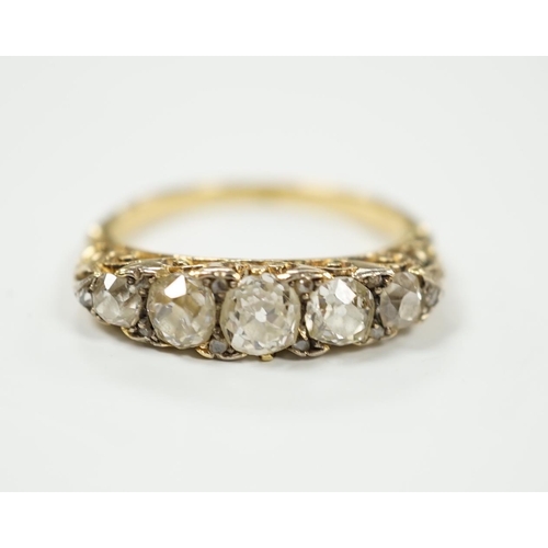 2020 - An early 20th century yellow metal and graduated five stone diamond set half hoop ring, with diamond... 