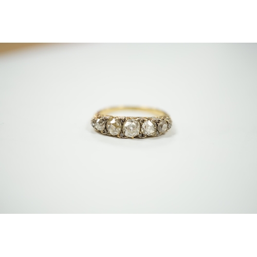 2020 - An early 20th century yellow metal and graduated five stone diamond set half hoop ring, with diamond... 