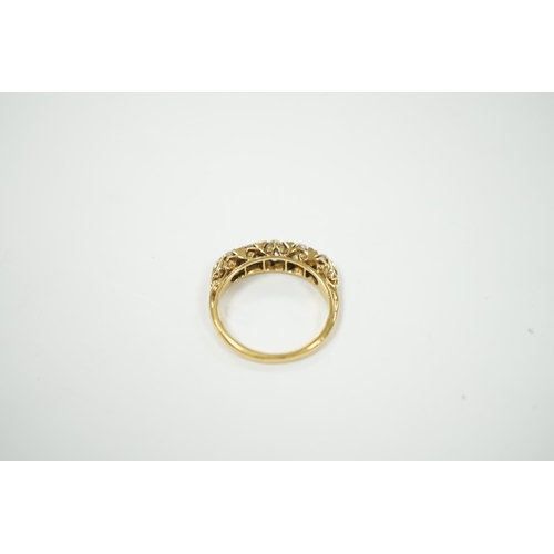 2020 - An early 20th century yellow metal and graduated five stone diamond set half hoop ring, with diamond... 