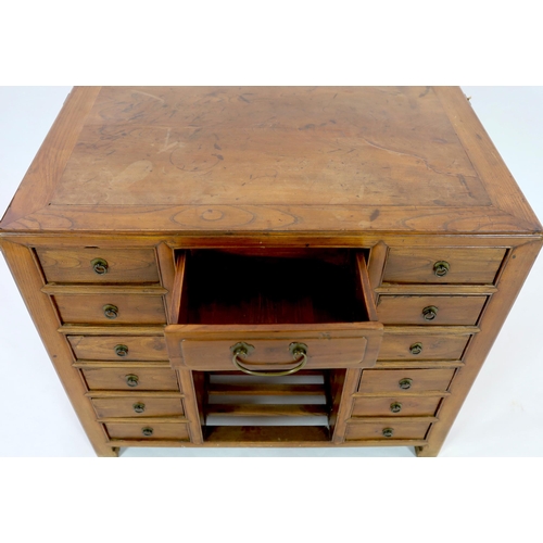 119 - A Chinese jumu kneehole desk, late Qing dynasty, fitted with an arrangement of thirteen drawers arou... 