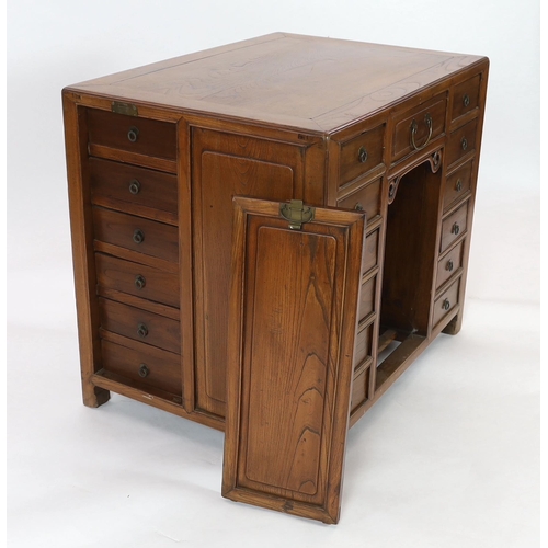 119 - A Chinese jumu kneehole desk, late Qing dynasty, fitted with an arrangement of thirteen drawers arou... 