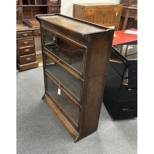 122 - An oak Globe Wernicke style three section bookcase, width 87cm, depth 30cm, height 113cm