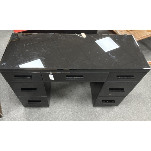 128 - A contemporary black glass kneehole desk, width 121cm, depth 45cm, height 83cm