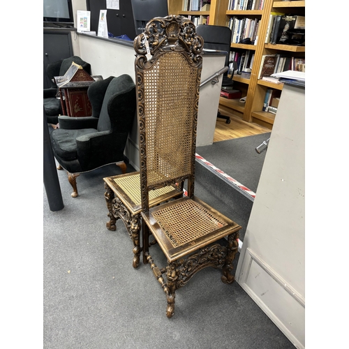 138 - A pair of Cromwellian style carved beech and walnut caned high back hall chairs, height 159cm.... 