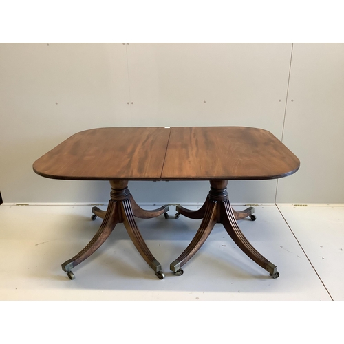 140 - A Regency mahogany two pillar dining table, with one spare leaf. Length 206cm extended, depth 107cm,... 