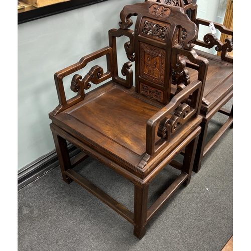 142 - A pair of Chinese carved hardwood elbow chairs width 65cm, depth 52cm, height 103cm.