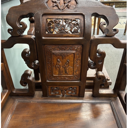 142 - A pair of Chinese carved hardwood elbow chairs width 65cm, depth 52cm, height 103cm.