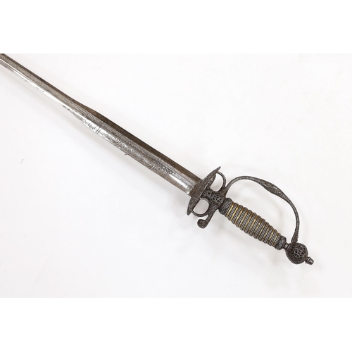 256 - An English iron hilted small sword, c.1765, chiselled and pierced with scrolling devices and foliage... 