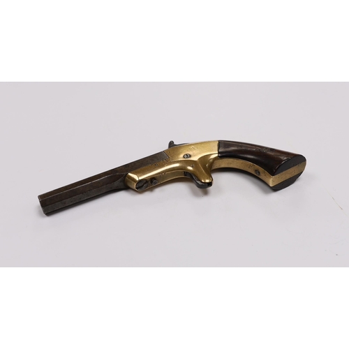 297 - A 19th century miniature percussion pistol with brass lock and octagonal barrel, stamped Morgan and ... 