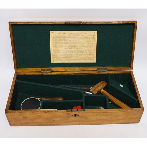 302 - An oak Colt pistol box, felt lined compartments containing a few tools including a bullet mould, lab... 