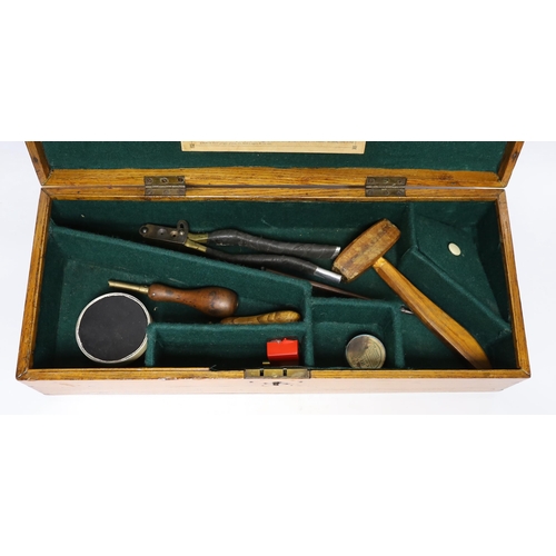 302 - An oak Colt pistol box, felt lined compartments containing a few tools including a bullet mould, lab... 