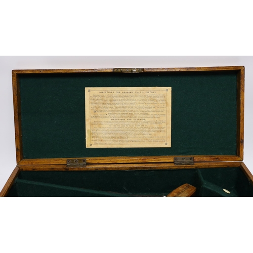 302 - An oak Colt pistol box, felt lined compartments containing a few tools including a bullet mould, lab... 