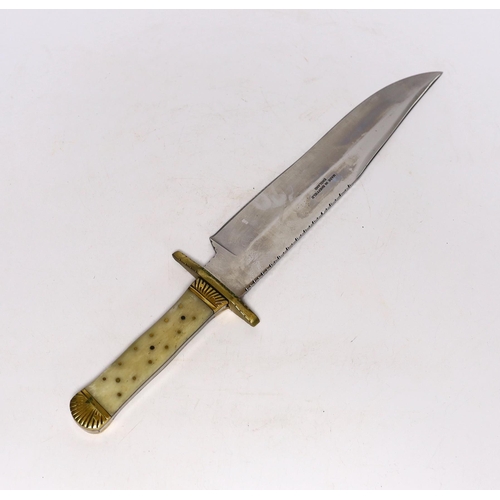 310 - A Bowie knife with clip point blade, unsharpened false edge and decorative filework, marked made in ... 