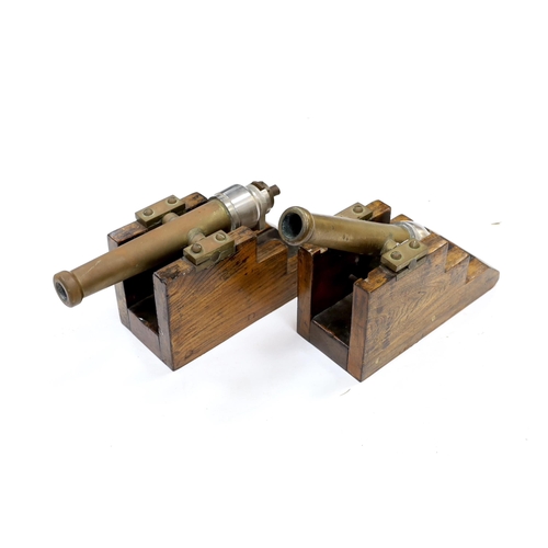 314 - A near pair of breech loading brass and steel starting cannons, on elm stands, longest barrel 24.5cm... 