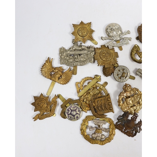 320 - Twenty-five military cap badges including Gloucestershire Regiment, East Surrey, West Riding Volunte... 