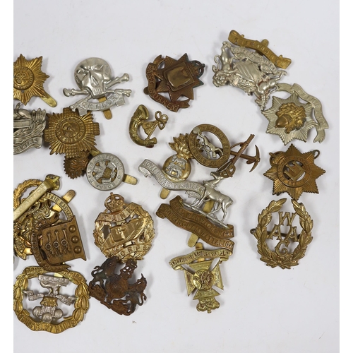 320 - Twenty-five military cap badges including Gloucestershire Regiment, East Surrey, West Riding Volunte... 