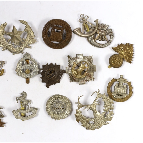 322 - Twenty military cap badges including Bedfordshire, West Yorkshire, Cornwall, East Lancashire, the Ro... 